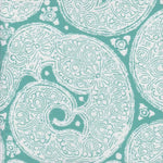 Detail of fabric in a paisley print in white on a turquoise field.