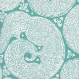 Detail of fabric in a paisley print in white on a turquoise field.