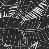 Detail of fabric in a large-scale leaf print in white on a charcoal field.