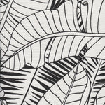 Detail of fabric in a large-scale leaf print in black on a white field.