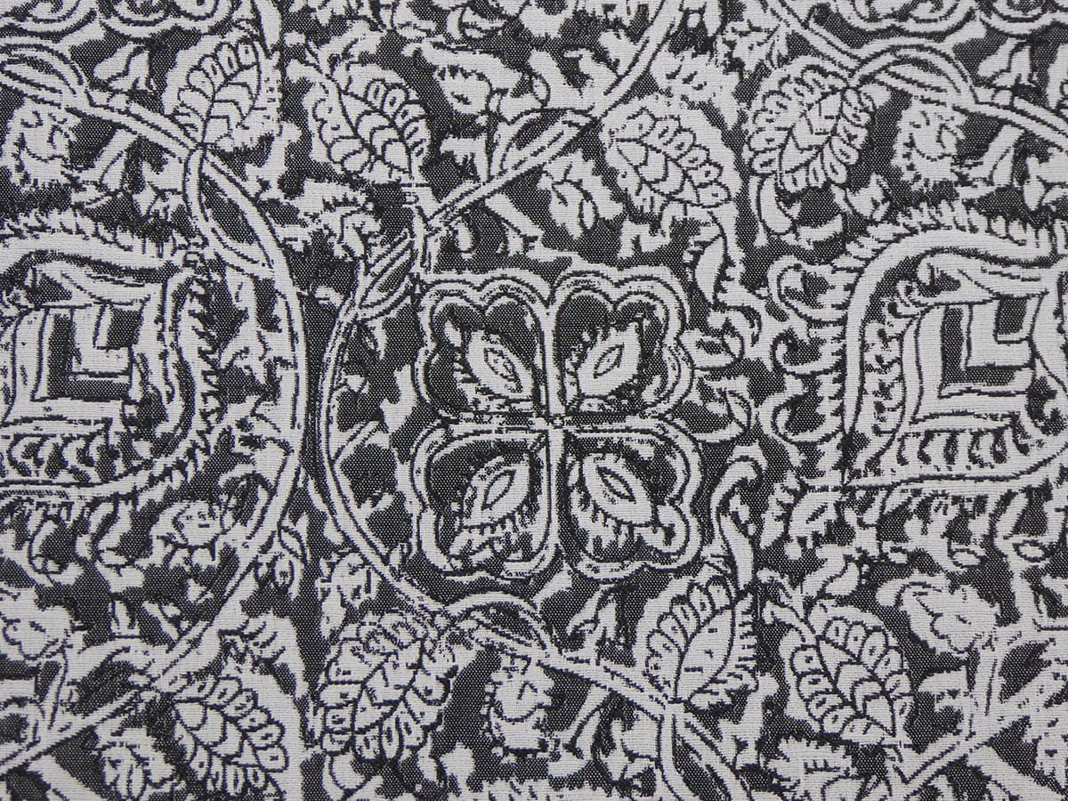 Detail of fabric in a painterly floral paisley in shades of gray and charcoal.