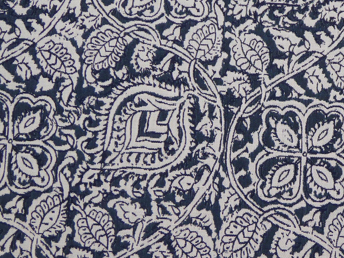 Detail of fabric in a painterly floral paisley in shades of gray and indigo.