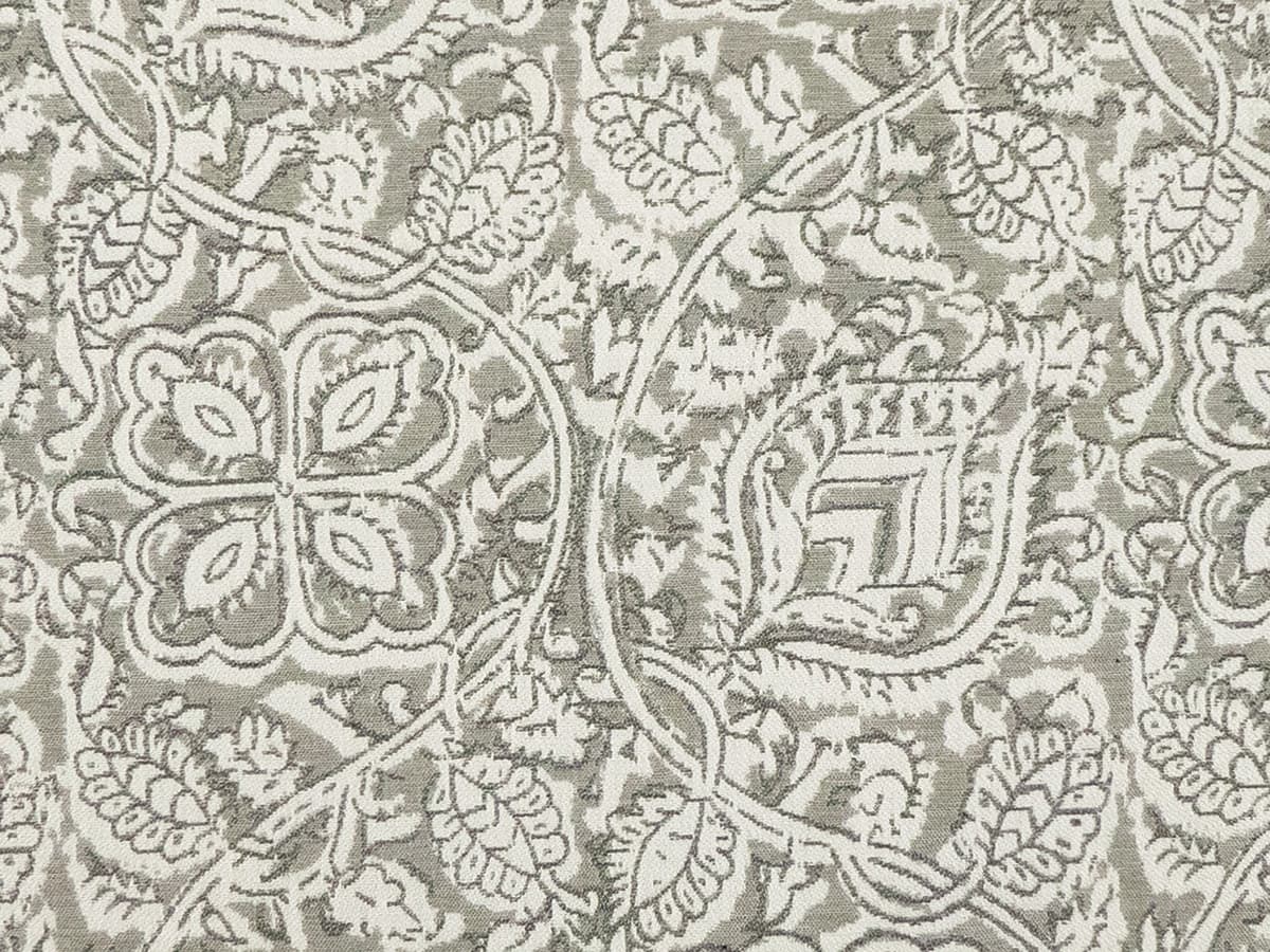 Detail of fabric in a painterly floral paisley in shades of light gray.