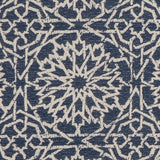 Detail of fabric in a small-scale lattice print in light brown on a navy field.