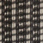 Detail of fabric in a textural shibori print in shades of charcoal on a greige field.