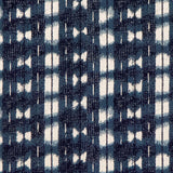 Detail of fabric in a textural shibori print in shades of navy on a greige field.