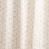 Draped fabric yardage in a painterly lattice print in tan on a cream field.