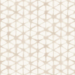 Detail of fabric in a painterly lattice print in tan on a cream field.