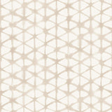 Detail of fabric in a painterly lattice print in tan on a cream field.