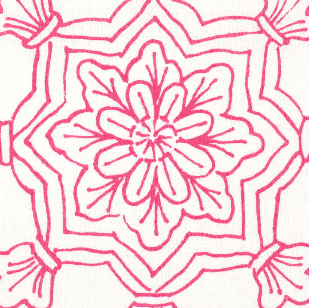 Detail of fabric in a floral medallion print in pink on a white field.