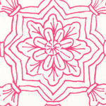 Detail of fabric in a floral medallion print in pink on a white field.