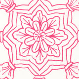 Detail of fabric in a floral medallion print in pink on a white field.