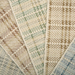 Close-up of f broadloom samples with plaid pattern in beige, brown, and blue.