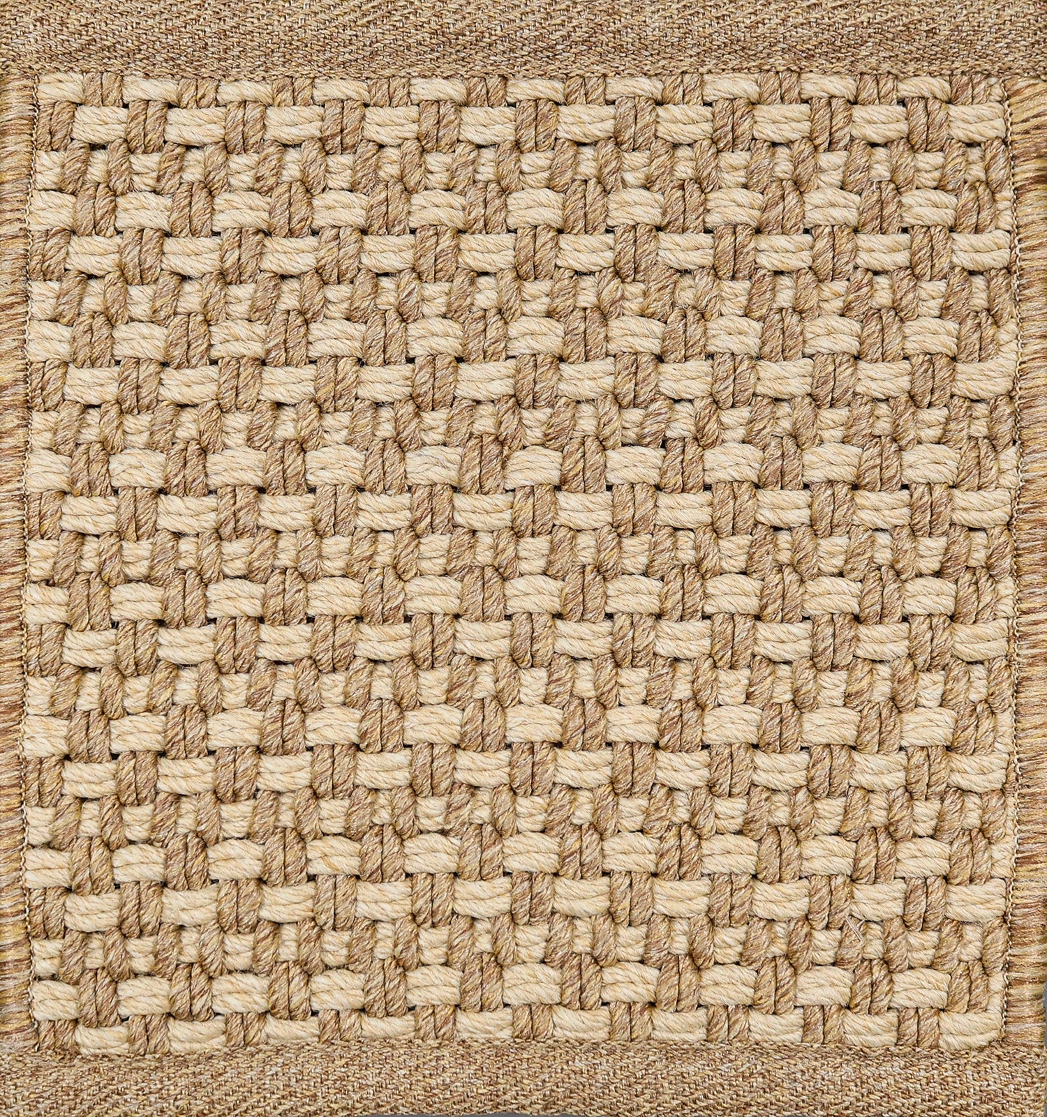 Textured woven outdoor carpet a basketweave design in tan.