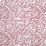 Fabric in a botanical paisley print in white on a dusty rose field.