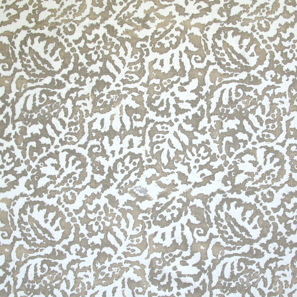 Fabric in a botanical paisley print in white on a tan field.