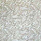 Fabric in a botanical paisley print in white on a tan field.