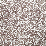 Fabric in a botanical paisley print in white on a brown field.