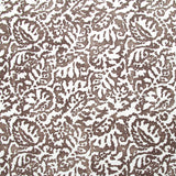 Fabric in a botanical paisley print in white on a brown field.