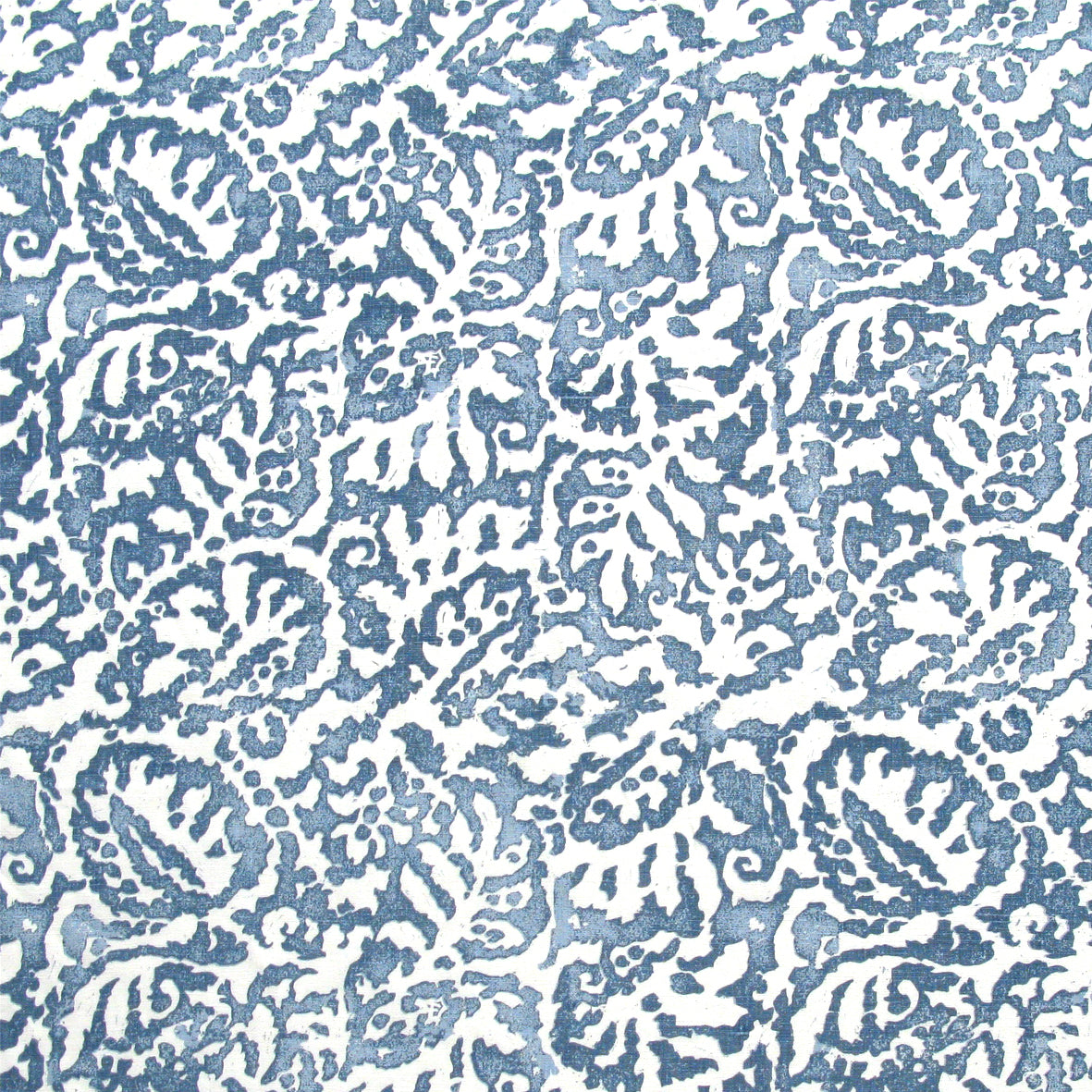 Fabric in a botanical paisley print in white on an indigo field.