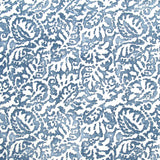 Fabric in a botanical paisley print in white on an indigo field.