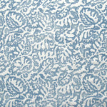 Fabric in a botanical paisley print in white on a blue field.