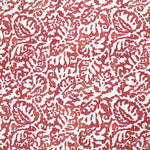 Fabric in a botanical paisley print in white on a red field.