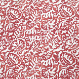 Fabric in a botanical paisley print in white on a red field.