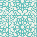 Detail of wallpaper in a small-scale lattice print in turquoise on a cream field.