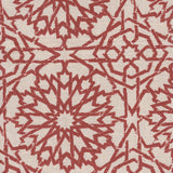 Detail of fabric in a small-scale lattice print in red on a cream field.