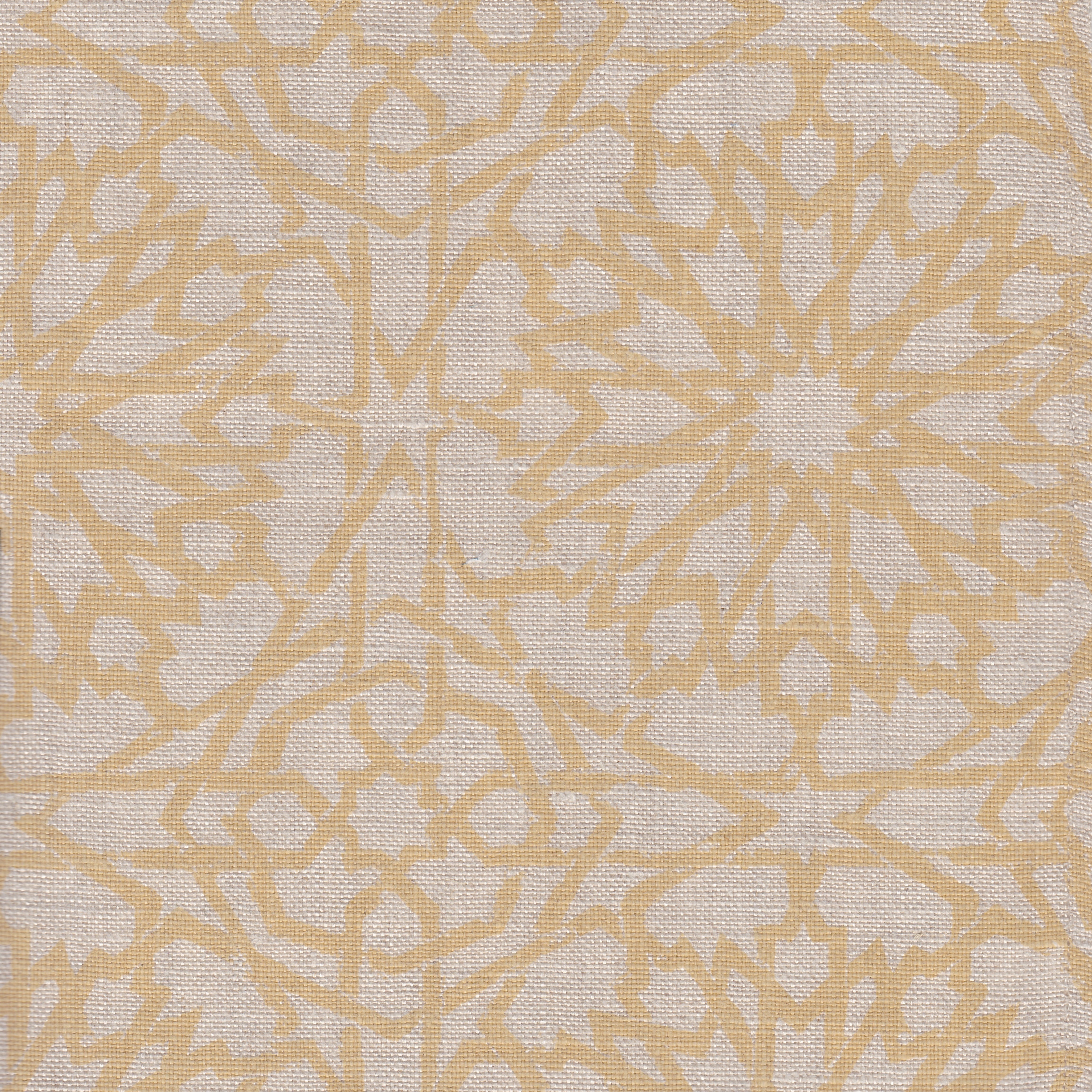 Detail of fabric in a small-scale lattice print in yellow on a cream field.