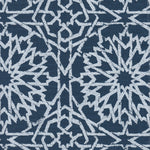 Detail of fabric in a small-scale lattice print in light blue on a navy field.