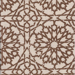 Detail of fabric in a small-scale lattice print in brown on a cream field.