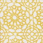 Detail of fabric in a small-scale lattice print in yellow on a white field.