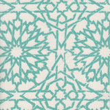 Detail of fabric in a small-scale lattice print in turquoise on a cream field.