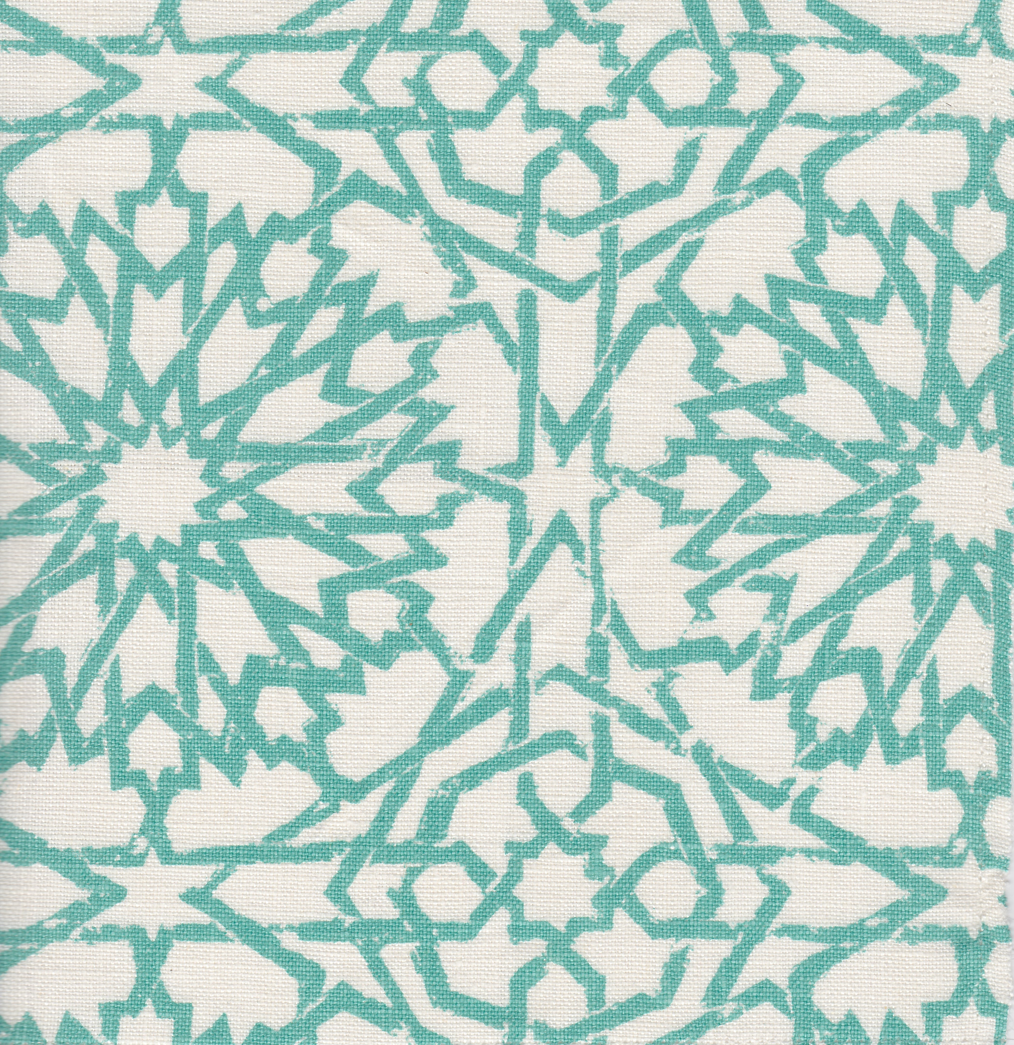 Detail of fabric in a small-scale lattice print in turquoise on a cream field.