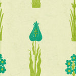 Detail of wallpaper in a playful floral print in green and turquoise on a cream field.