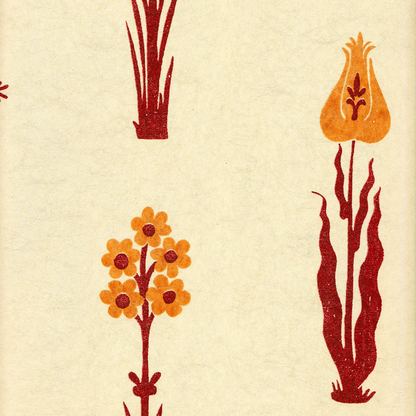 Detail of wallpaper in a playful floral print in red and orange on a cream field.