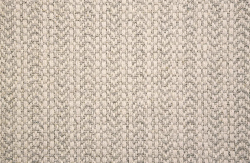 Broadloom carpet swatch in a herringbone pattern in a light grey design