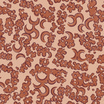 Wallpaper detail in a painterly botanical lace pattern in tonal shades of rust red.