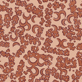 Wallpaper detail in a painterly botanical lace pattern in tonal shades of rust red.