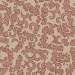 Wallpaper detail in a painterly botanical lace pattern in tonal shades of terracotta pink.