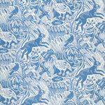 Detail of wallpaper in a playful rabbit and bird print in white on a blue field.