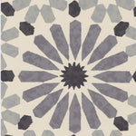 Detail of wallpaper in a geometric lattice print in shades of black, blue and gray on a cream field.