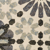 Detail of fabric in a geometric lattice print in shades of black, blue and gray on a cream field.