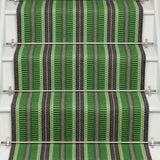 Striped flatweave runner in green and black on white staircase