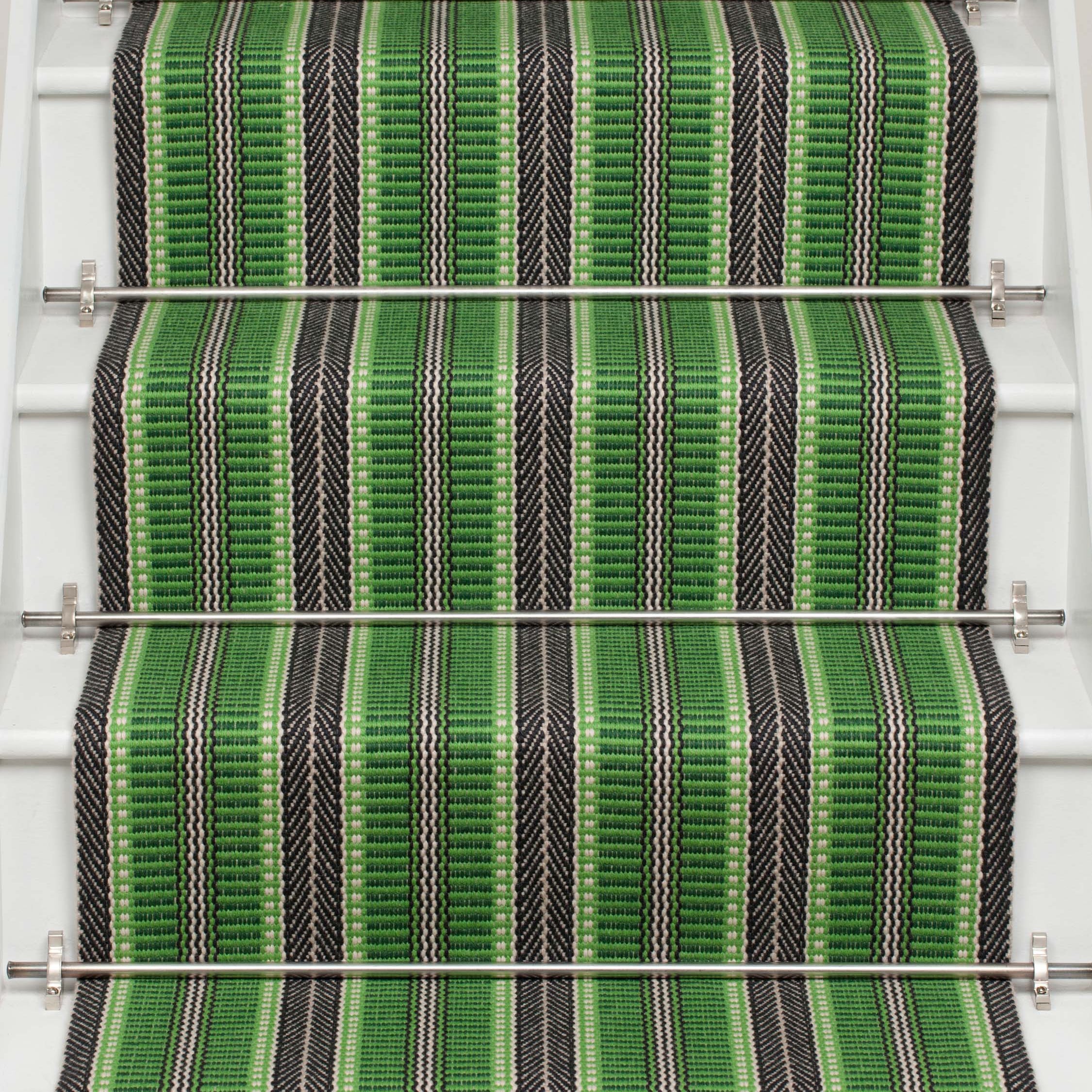 Striped flatweave runner in green and black on white staircase