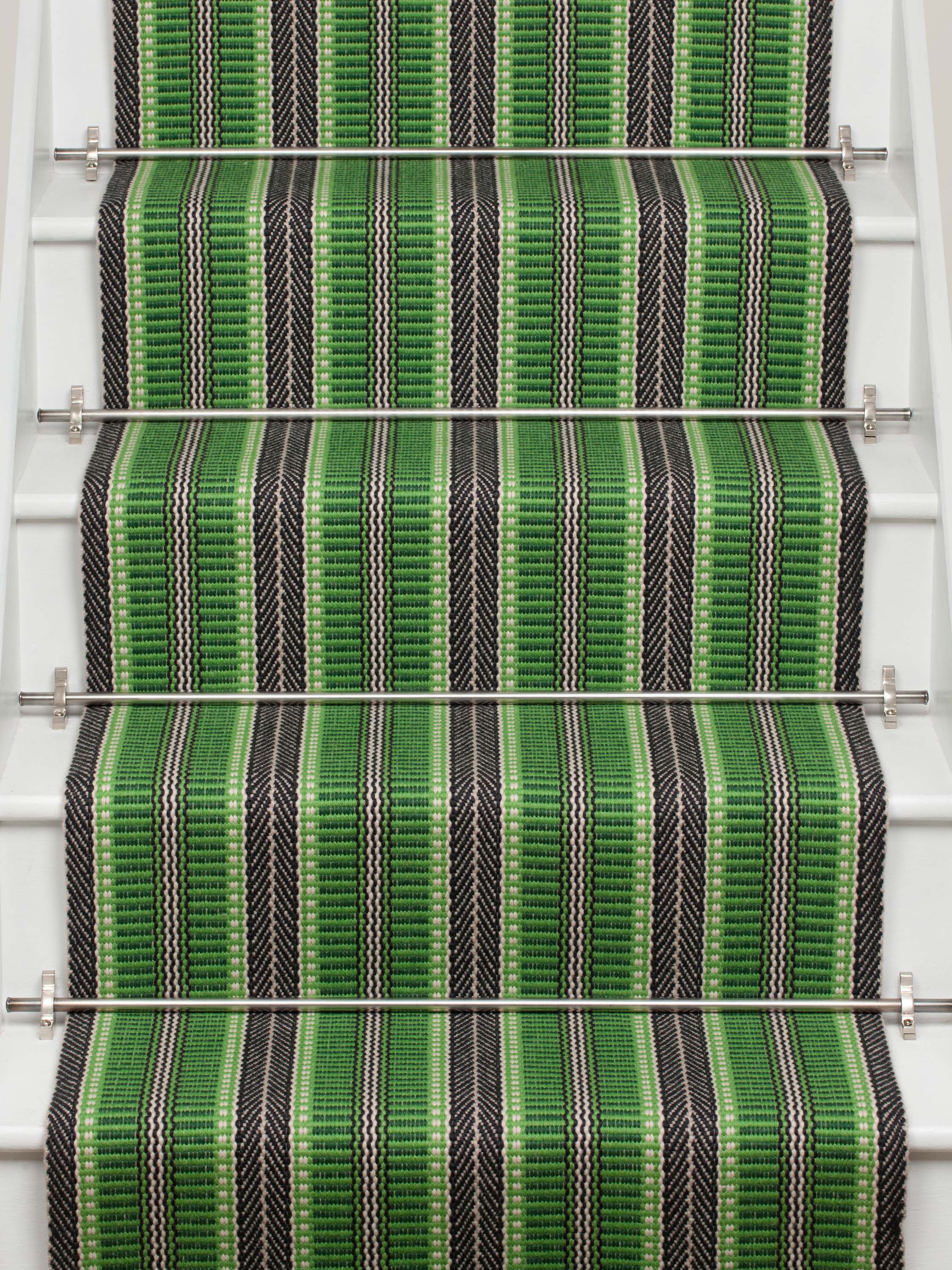 Striped flatweave runner in green and black on white staircase