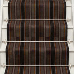 Striped flatweave runner in orange brown and black on white staircase