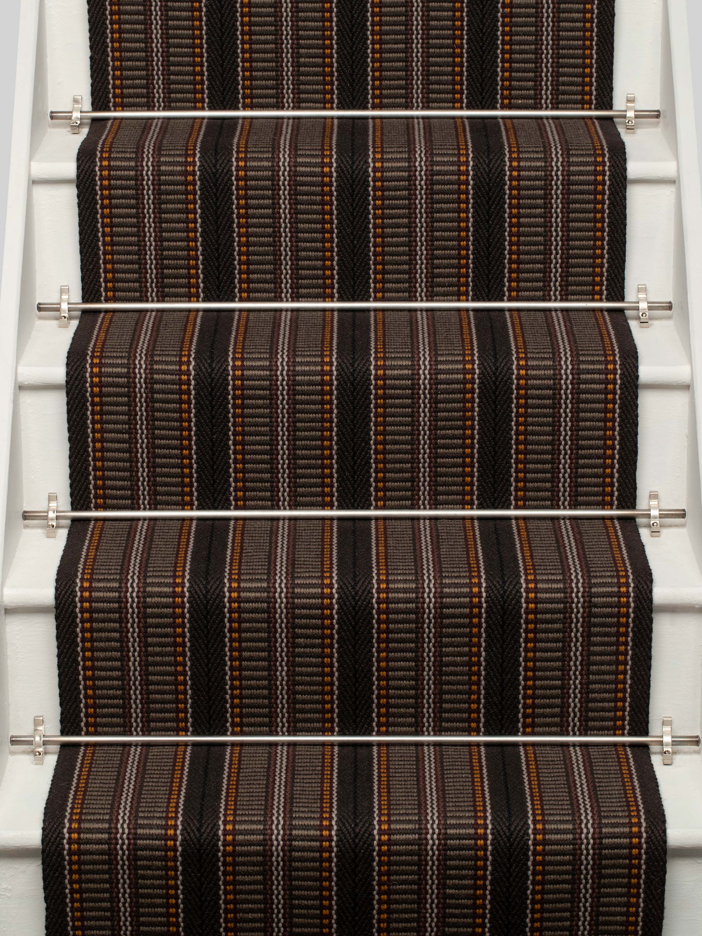 Striped flatweave runner in orange brown and black on white staircase